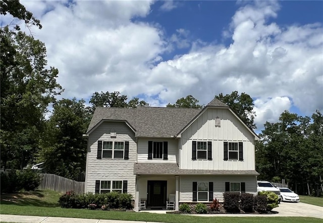view of front facade with board and batten siding and roof with shingles