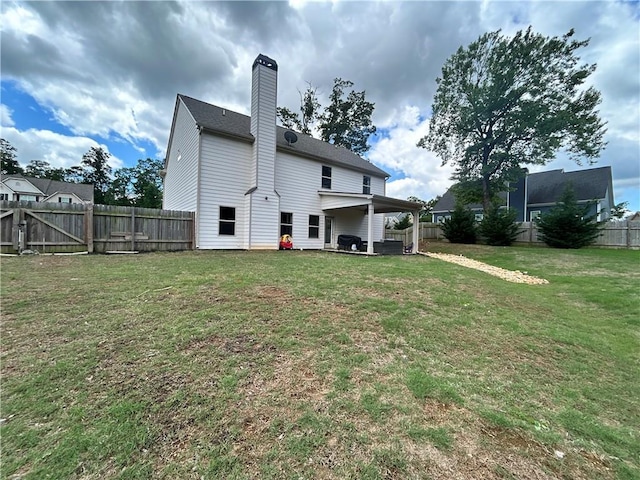 rear view of house featuring a patio area and a chimney
