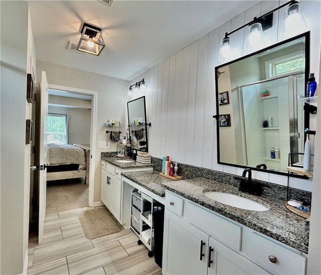 ensuite bathroom with a shower stall and vanity