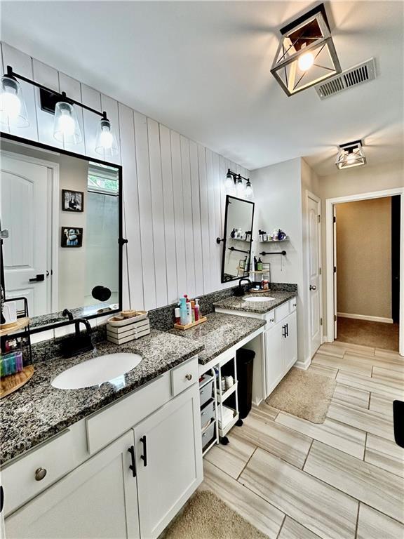 bathroom with vanity and baseboards