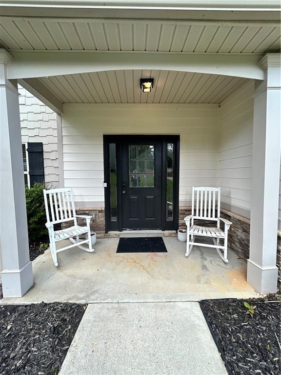 view of exterior entry with covered porch