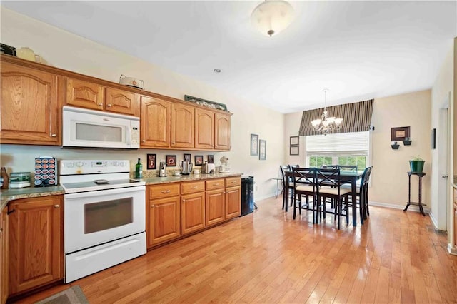 250 Brianna Blvd, Calhoun, GA 30701 - kitchen with white appliances, a chandelier, and brown cabinetry