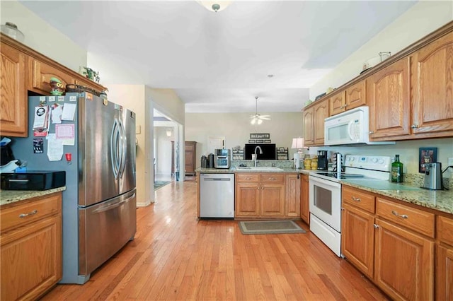 250 Brianna Blvd, Calhoun, GA 30701 - kitchen with stainless steel appliances, a peninsula, a ceiling fan, light wood-type flooring, and brown cabinets