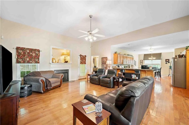 250 Brianna Blvd, Calhoun, GA 30701 - living room featuring a fireplace with flush hearth, light wood-style floors, ceiling fan, and a chandelier