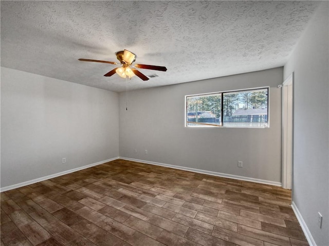 unfurnished room featuring a textured ceiling, ceiling fan, and dark hardwood / wood-style floors