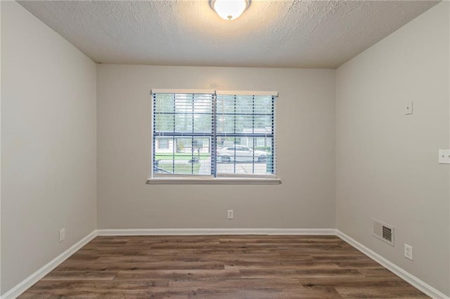 2045 Scarbrough Dr, Stone Mountain, GA 30088 - empty room featuring wood finished floors, a textured ceiling, and baseboards