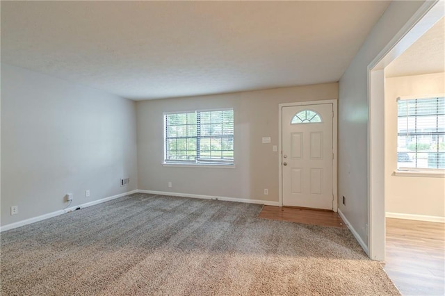 2045 Scarbrough Dr, Stone Mountain, GA 30088 - foyer with light colored carpet and baseboards