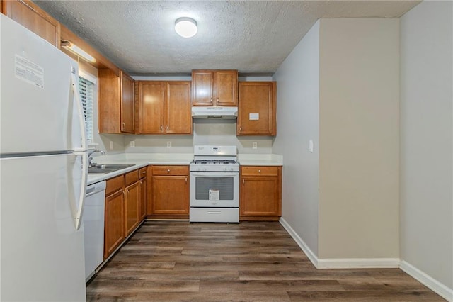 2045 Scarbrough Dr, Stone Mountain, GA 30088 - kitchen featuring white appliances, a sink, dark wood finished floors, under cabinet range hood, and light countertops