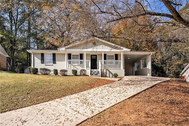 ranch-style home with a front lawn, a porch, and a carport