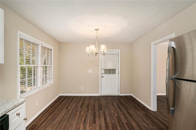 896 Meadow Rock Way, Stone Mountain, GA 30083 - unfurnished dining area with a textured ceiling, dark hardwood / wood-style floors, and a notable chandelier