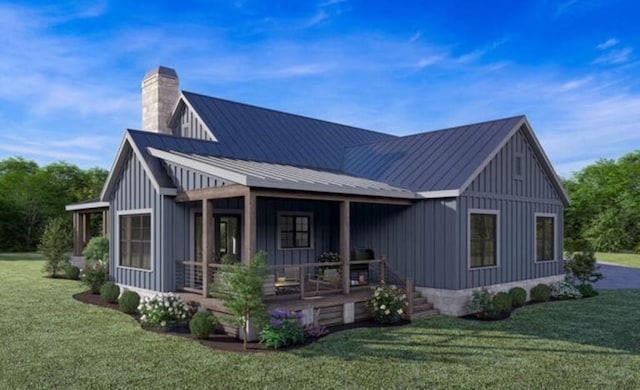 rear view of house with board and batten siding, a lawn, a porch, and a chimney