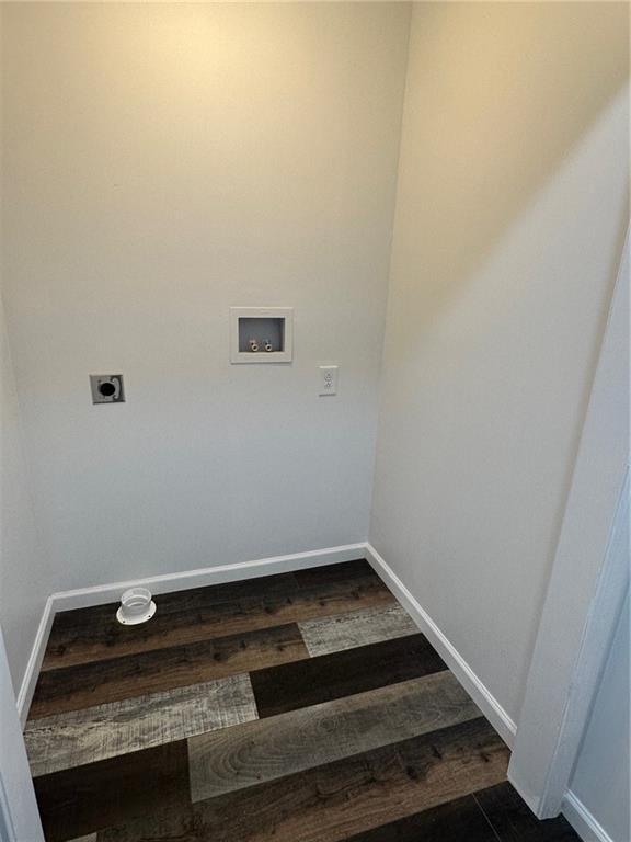 laundry room featuring hookup for an electric dryer, dark hardwood / wood-style floors, and washer hookup