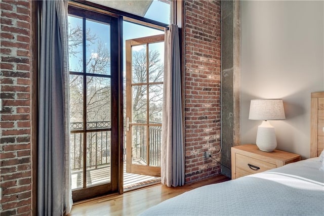 bedroom featuring hardwood / wood-style floors and access to outside