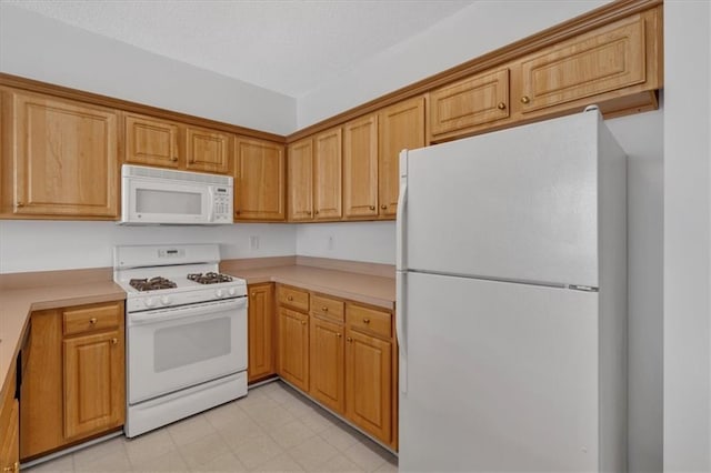 kitchen featuring white appliances and light tile patterned floors