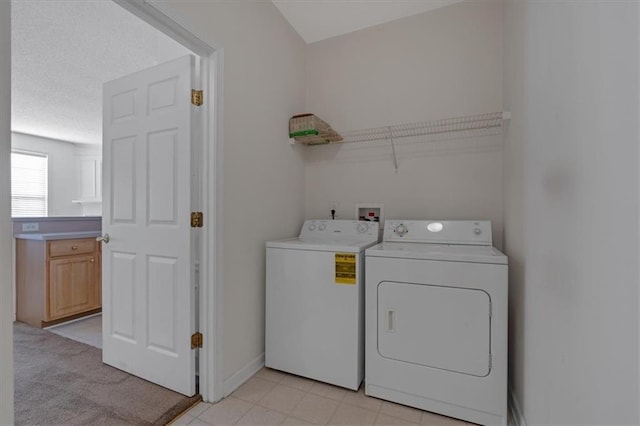 laundry area with washing machine and dryer and light carpet