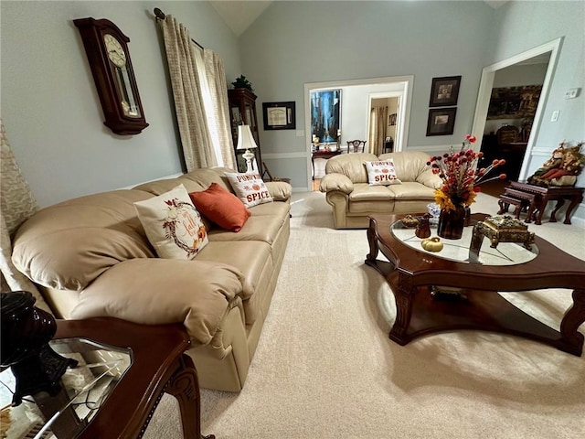 carpeted living room with vaulted ceiling