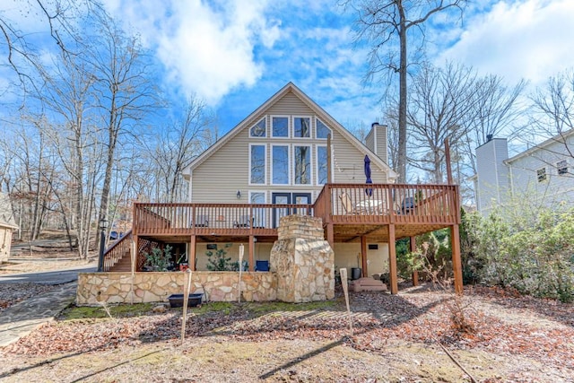 rear view of property with a wooden deck