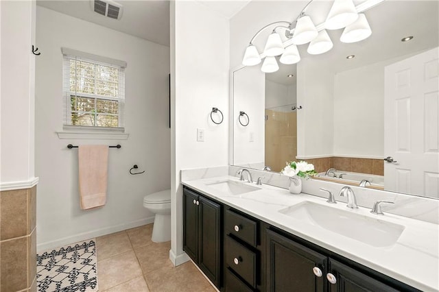 bathroom with tile patterned flooring, visible vents, a sink, and a walk in shower