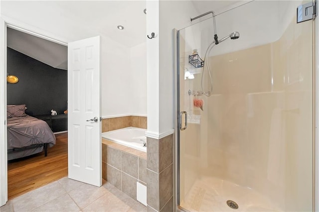 bathroom with tile patterned flooring, a garden tub, connected bathroom, and a shower stall