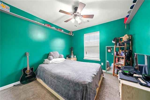 carpeted bedroom featuring a ceiling fan, visible vents, and baseboards