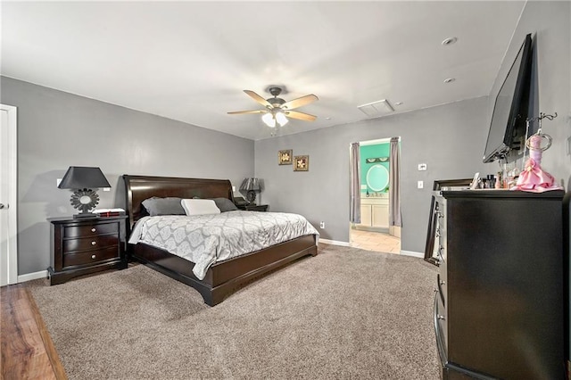 bedroom with ceiling fan, connected bathroom, and baseboards