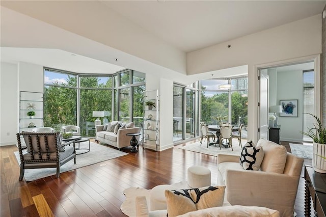 living room featuring a wealth of natural light and dark hardwood / wood-style floors