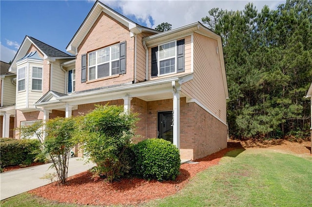 4844 W Park Cir Unit 4844, College Park, GA 30349 - view of home's exterior featuring brick siding, a lawn, covered porch, and driveway