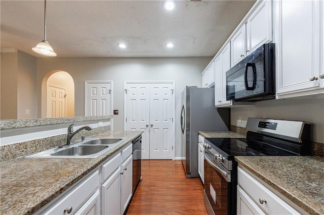 4844 W Park Cir Unit 4844, College Park, GA 30349 - kitchen with black microwave, electric stove, a sink, a textured ceiling, and wood finished floors