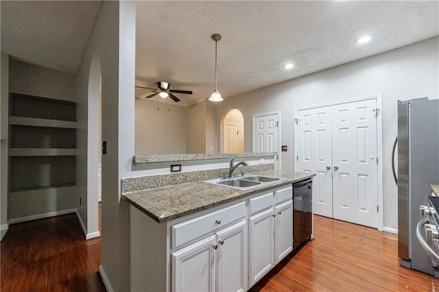 4844 W Park Cir Unit 4844, College Park, GA 30349 - kitchen with arched walkways, a sink, dishwasher, light wood finished floors, and freestanding refrigerator