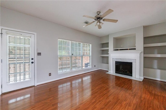 4844 W Park Cir Unit 4844, College Park, GA 30349 - unfurnished living room with ceiling fan, baseboards, healthy amount of natural light, and built in features