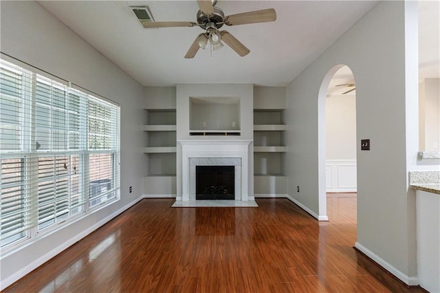 4844 W Park Cir Unit 4844, College Park, GA 30349 - unfurnished living room with ceiling fan, wood finished floors, arched walkways, a premium fireplace, and built in shelves