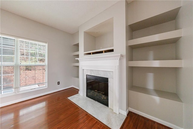 4844 W Park Cir Unit 4844, College Park, GA 30349 - unfurnished living room featuring baseboards, a premium fireplace, and wood finished floors
