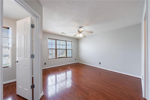 4844 W Park Cir Unit 4844, College Park, GA 30349 - empty room featuring ceiling fan, a textured ceiling, dark wood-style flooring, and baseboards