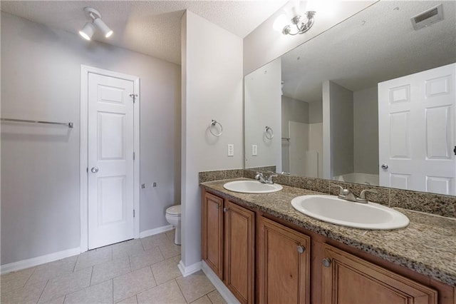 4844 W Park Cir Unit 4844, College Park, GA 30349 - full bath featuring a textured ceiling, baseboards, tile patterned flooring, double vanity, and toilet