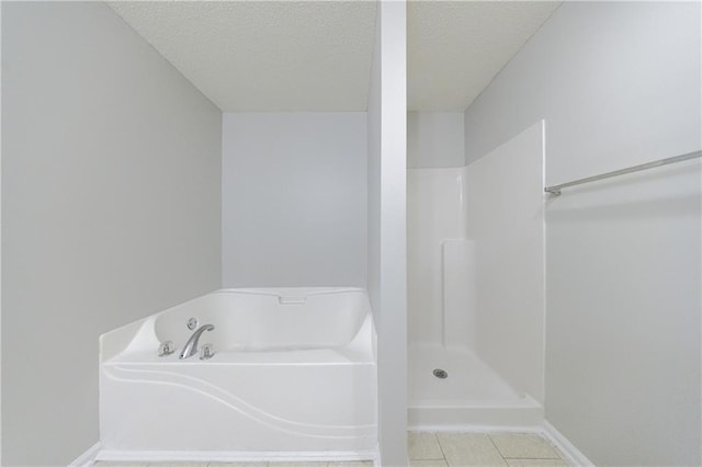 4844 W Park Cir Unit 4844, College Park, GA 30349 - full bathroom featuring a textured ceiling, a garden tub, baseboards, a shower, and tile patterned floors