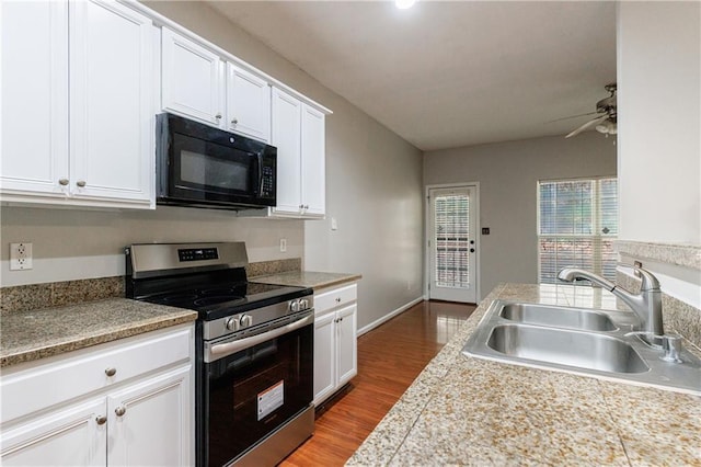4844 W Park Cir Unit 4844, College Park, GA 30349 - kitchen with black microwave, stainless steel electric stove, a sink, a ceiling fan, and white cabinets