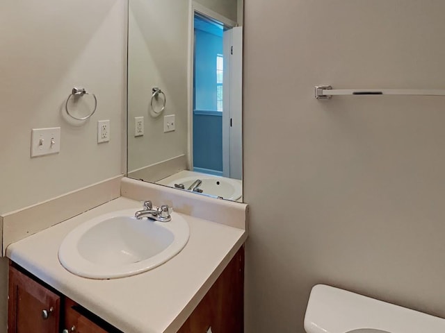 half bath featuring toilet and vanity