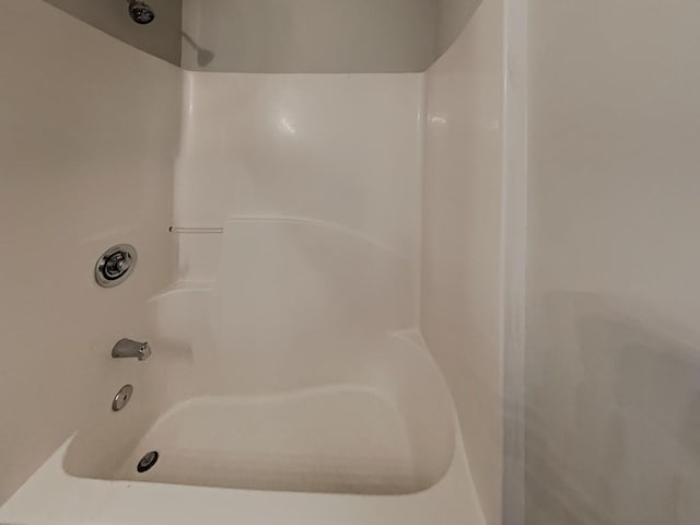 full bathroom with walk in shower and a tub