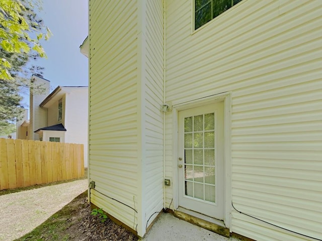 view of side of home featuring fence