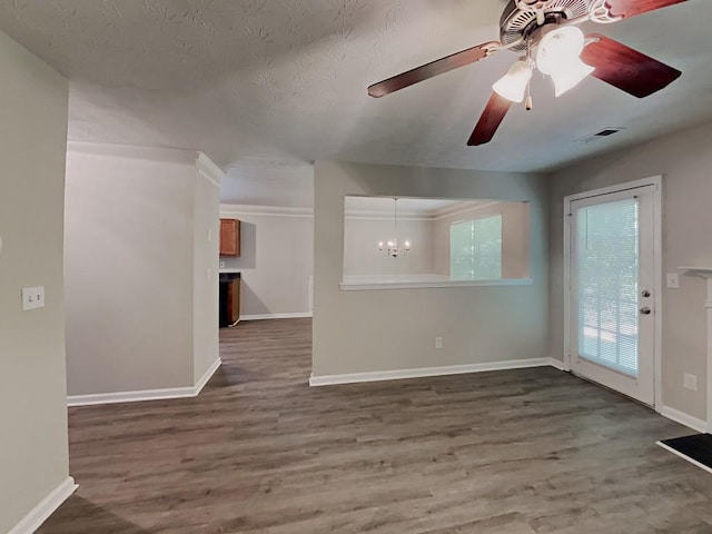 unfurnished living room with wood finished floors, baseboards, and ceiling fan with notable chandelier