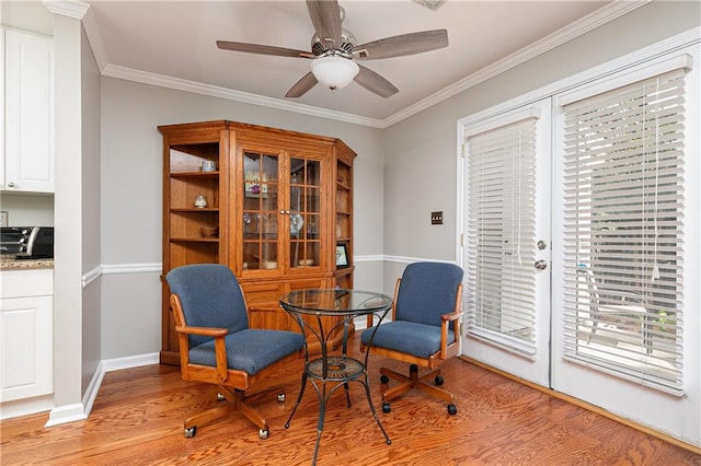 sitting room featuring light hardwood / wood-style floors, ceiling fan, and ornamental molding