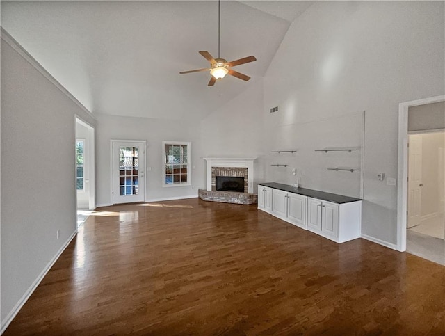 unfurnished living room with ceiling fan, high vaulted ceiling, and dark hardwood / wood-style floors