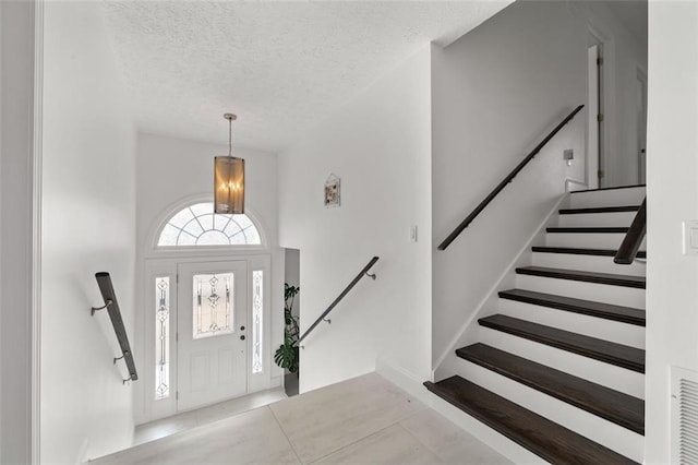 entrance foyer with a textured ceiling