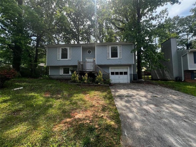 raised ranch with driveway and a garage