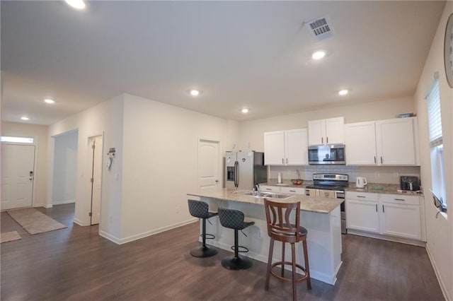 357 Hughes Ln, Pendergrass, GA 30567 - kitchen with stainless steel appliances, a center island with sink, dark wood finished floors, white cabinets, and recessed lighting