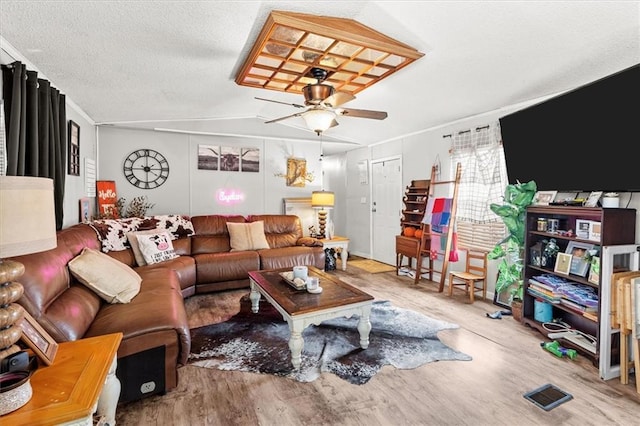 living room with visible vents, a ceiling fan, lofted ceiling, and wood finished floors