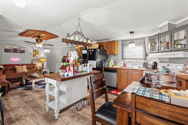 kitchen with light wood-type flooring, under cabinet range hood, stainless steel dishwasher, range, and black refrigerator with ice dispenser