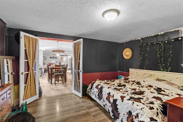 bedroom with wood finished floors and a textured ceiling