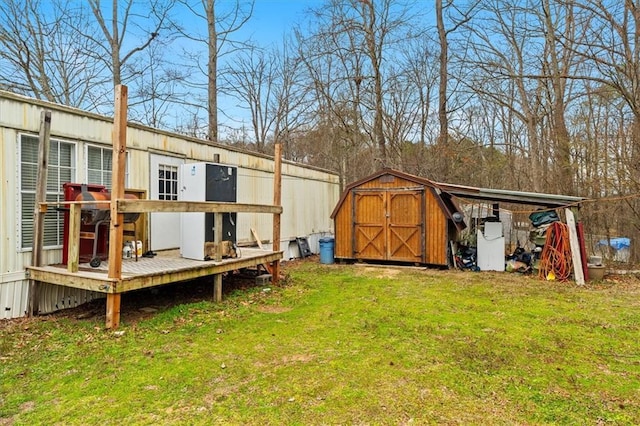 view of yard with a wooden deck, an outbuilding, and a shed