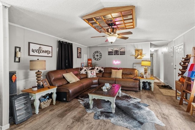 living area with wood finished floors, stairs, and ornamental molding